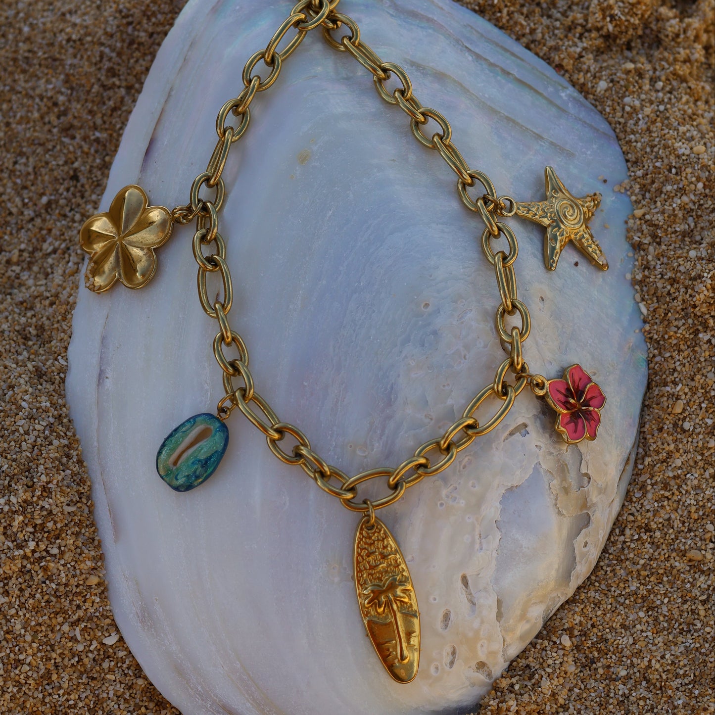 Chunky necklace with surfboard, hibiscus, starfish, plumeria, cowrie, pink, blue and gold and palm tree - moana swirl heart of tefiti